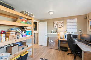 Home office with light hardwood / wood-style floors