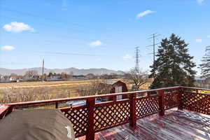 Deck with a mountain view and a storage shed