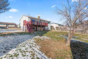 Rear view of property featuring a deck