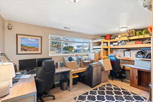 Home office with light hardwood / wood-style flooring