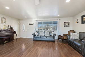 Living room with dark hardwood / wood-style floors and a textured ceiling