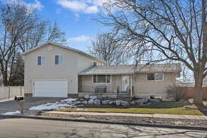 View of front facade with a garage and a porch