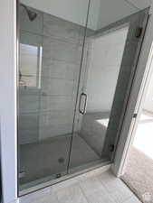 Bathroom with tile patterned floors and an enclosed shower