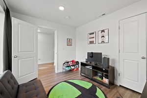 Recreation room with hardwood / wood-style flooring