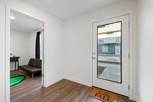 Doorway with hardwood / wood-style flooring