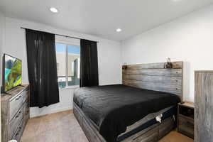 Bedroom with light colored carpet