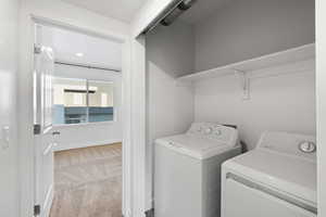 Laundry area featuring washer and dryer and carpet floors