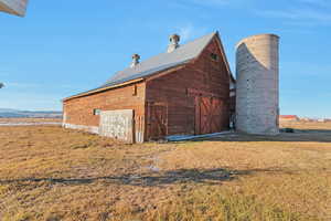 View of outdoor structure featuring a yard