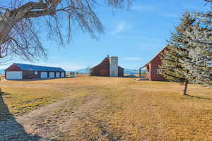 View of yard featuring an outdoor structure and a garage