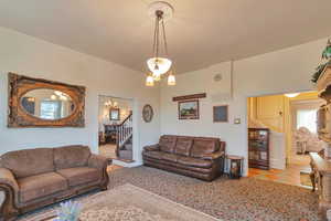 Living room with light tile patterned floors and a chandelier