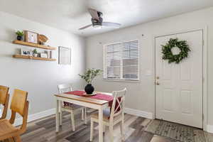 Dining room with dark wood-type flooring and ceiling fan