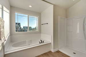 Bathroom featuring hardwood / wood-style floors and separate shower and tub