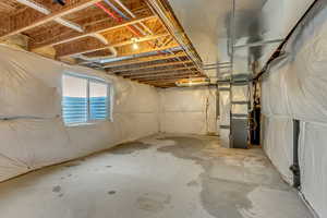 Basement featuring heating unit