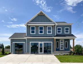 View of property with covered porch and 3-car garage