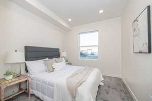 Bedroom featuring light colored carpet