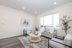 Living room with dark hardwood / wood-style flooring