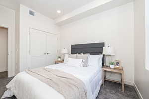 Carpeted bedroom featuring a closet