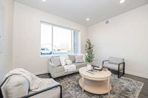 Living room with dark hardwood / wood-style flooring