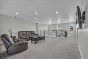 Carpeted living room with an inviting chandelier