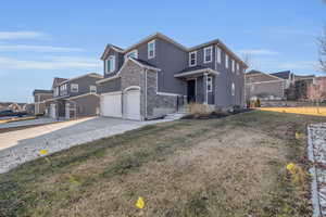 View of property with a front lawn and a garage