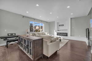 Living room with dark wood-type flooring