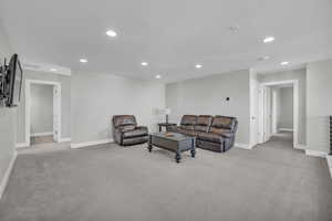 Living room with a textured ceiling and light carpet