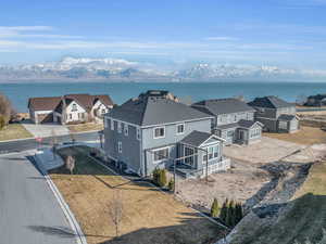 Birds eye view of property with a water and mountain view