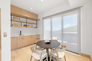 Dining space featuring light wood-type flooring and sink