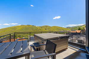 Wooden deck with a mountain view and a hot tub