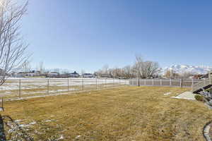 View of yard featuring a rural view and a mountain view