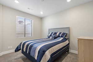 Bedroom with light colored carpet