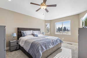 Carpeted bedroom featuring ceiling fan