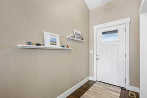 Entryway with dark hardwood / wood-style flooring