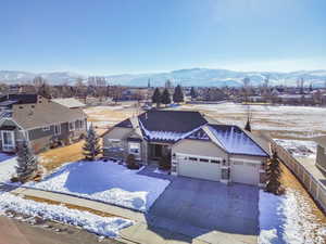 Snowy aerial view featuring a mountain view