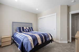 Carpeted bedroom with a closet