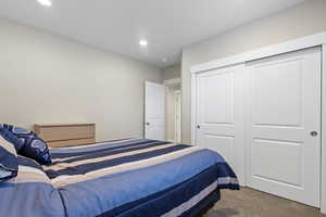 Carpeted bedroom with a closet