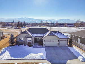 View of front of property with a mountain view and a garage