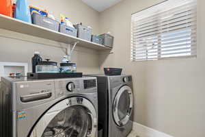 Clothes washing area featuring washer and clothes dryer