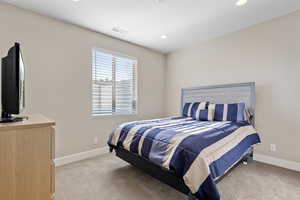 Bedroom with light colored carpet