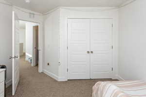 Bedroom with carpet and a closet