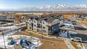 Snowy aerial view featuring a mountain view