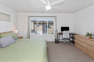 Bedroom featuring light carpet and ceiling fan