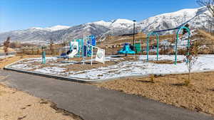 Snow covered playground with a mountain view