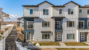 Townhome / multi-family property featuring a mountain view