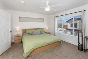 Bedroom with ceiling fan and carpet flooring