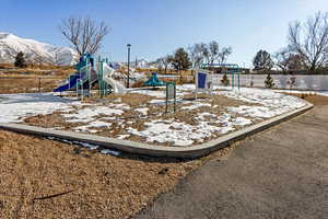 View of jungle gym with a mountain view