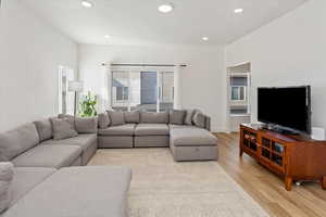 Living room with light hardwood / wood-style floors