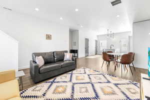 Living room with hardwood / wood-style flooring and sink