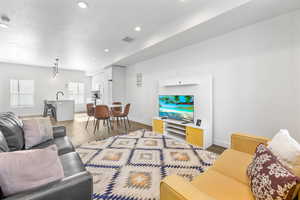 Living room featuring sink and hardwood / wood-style floors