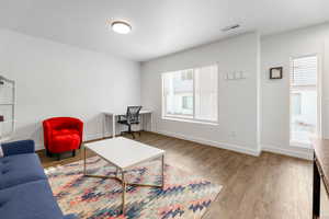 Living room featuring hardwood / wood-style flooring and plenty of natural light